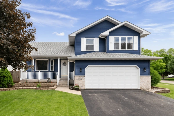 exterior-suburban-home-blue-siding-600nw-1884651355 https://illinoishomehero.com/wp-content/uploads/2025/11/exterior-suburban-home-blue-siding-600nw-1884651355.webp